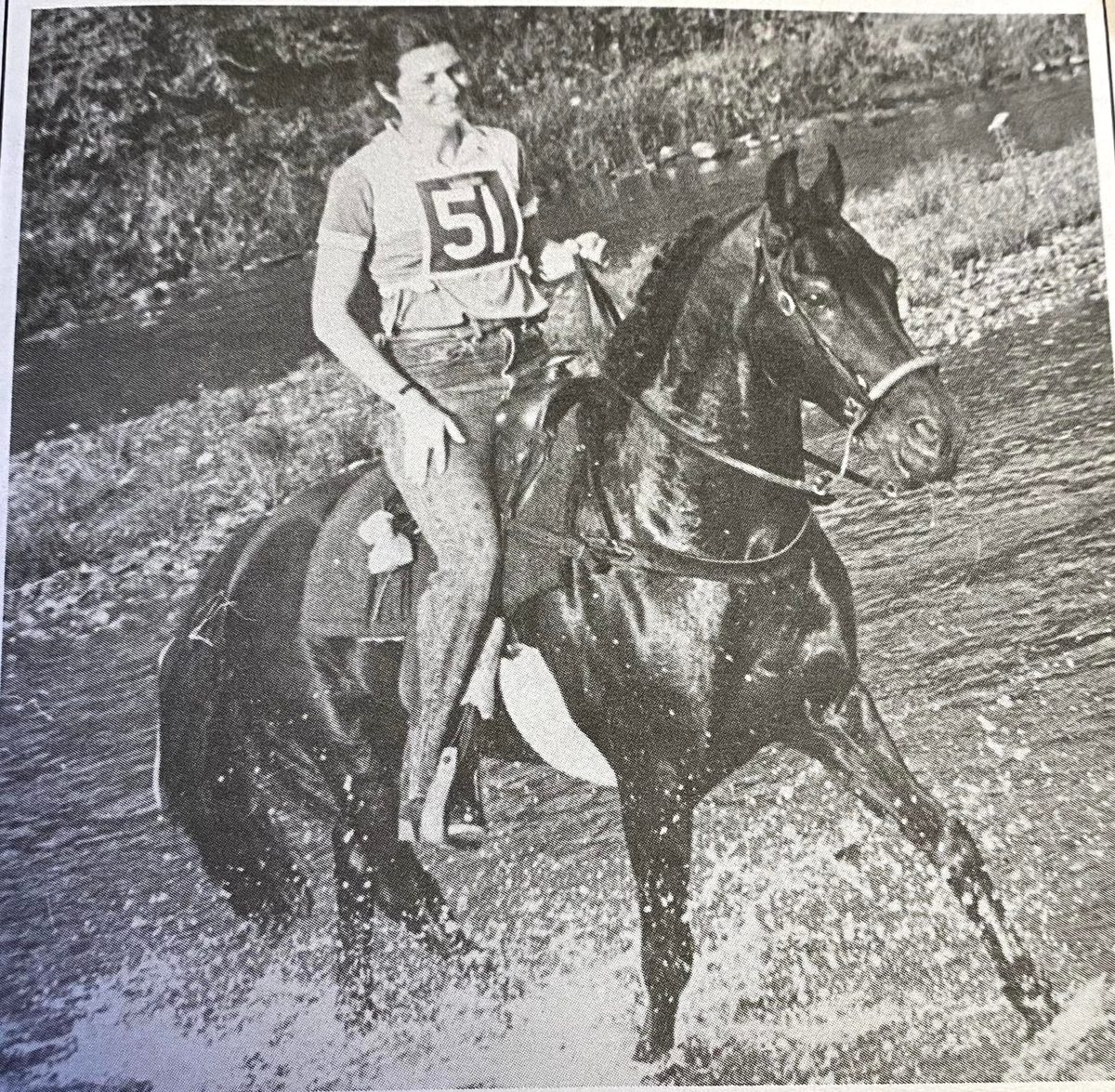 Vintage photograph of a rider crossing rough terrain on the Lippitt stallion Equinox Royalty in competitive trail